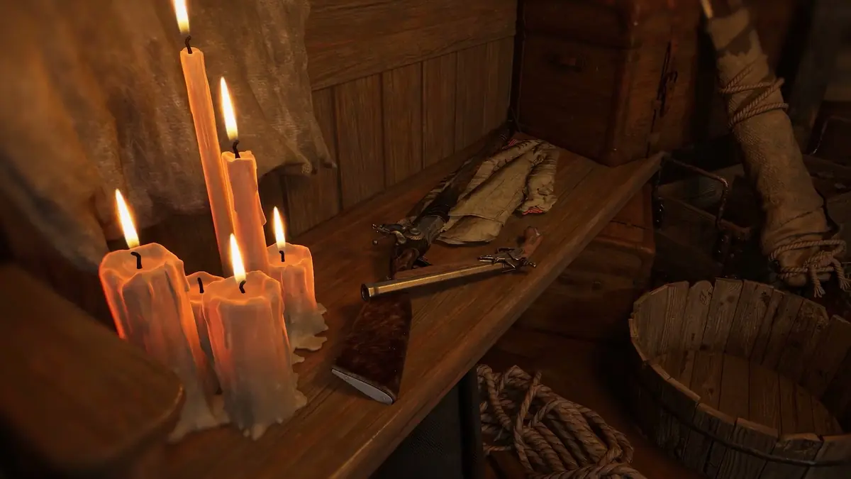 Official Valor Mortis trailer still of a candlelit interior with a workbench visible