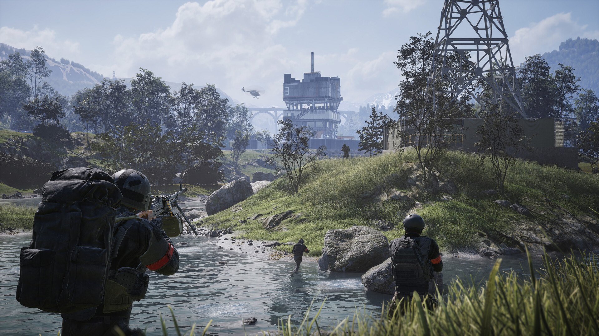 Official WARDOGS screenshot of soldiers wading across a river toward an industrial structure with a helicopter overhead